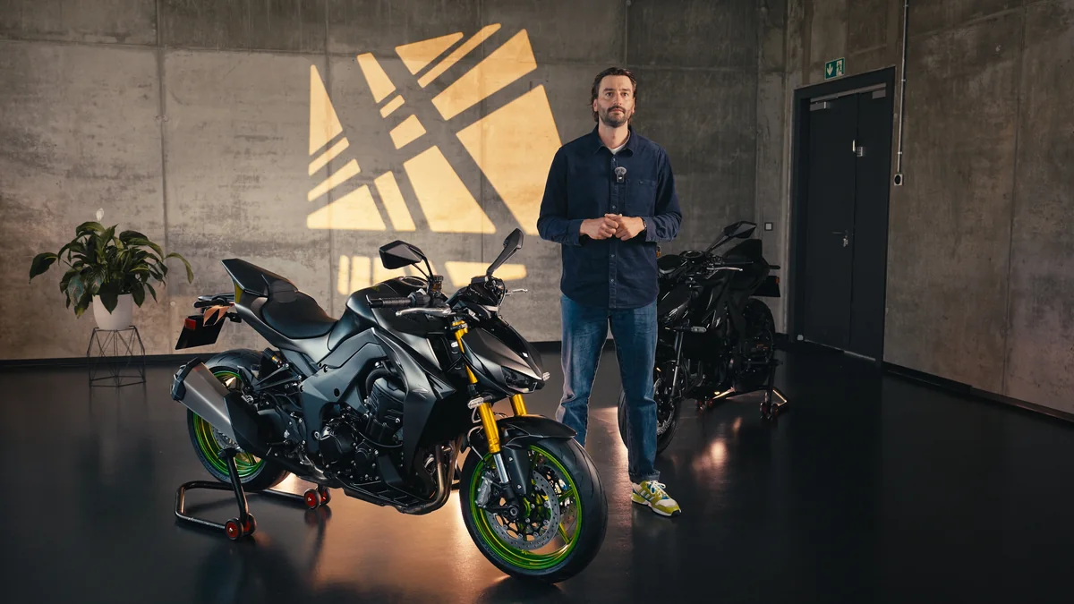 Motorcycle and two people in a Kawasaki showroom