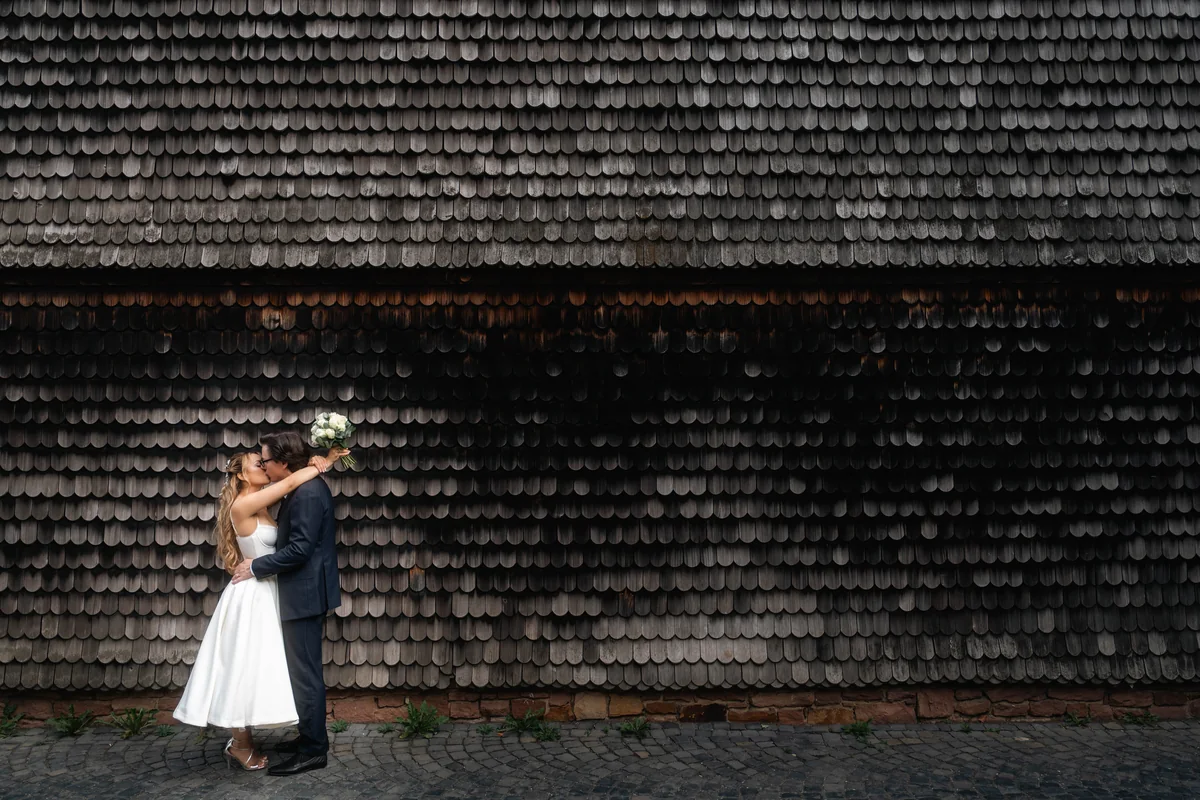 Wedding couple before a graphic wall