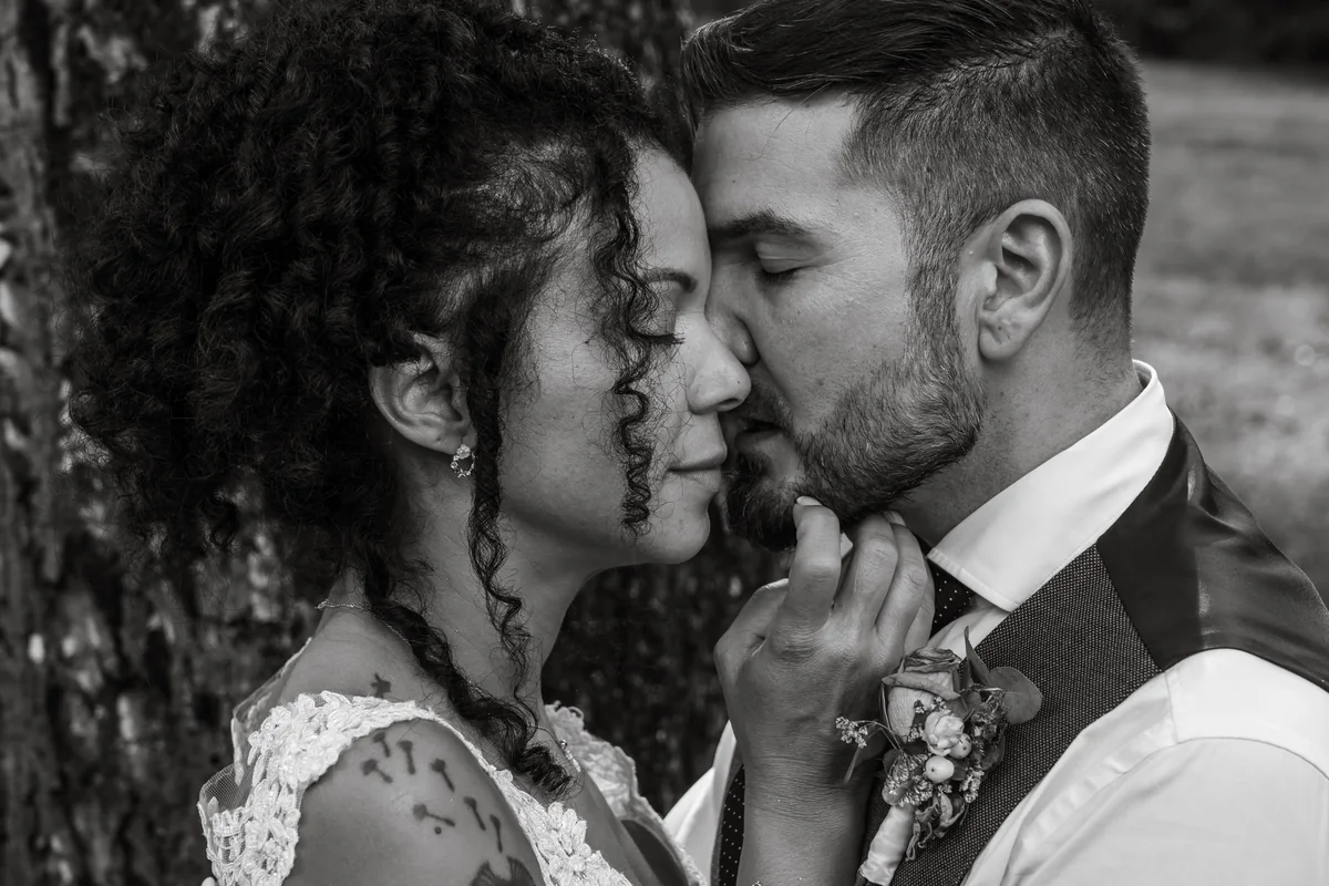 An intimate black-and-white moment between a wedding couple