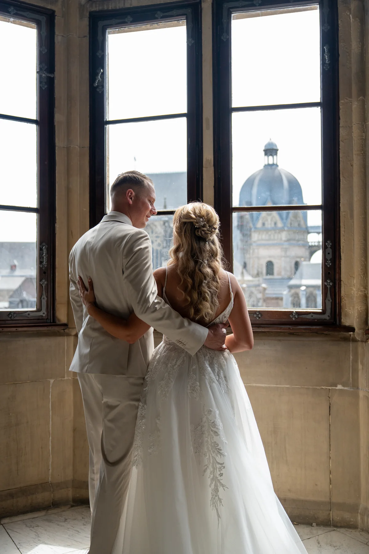 Wedding couple sharing a quiet moment by a window